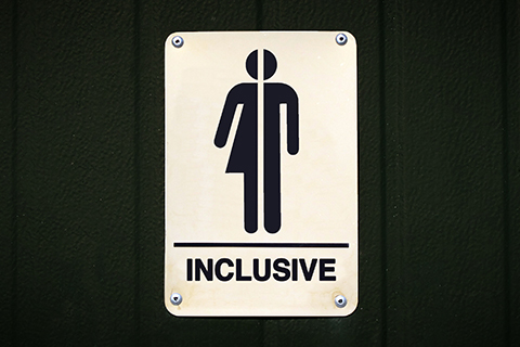 A stock photo focused on a sign which reads "inclusive."
